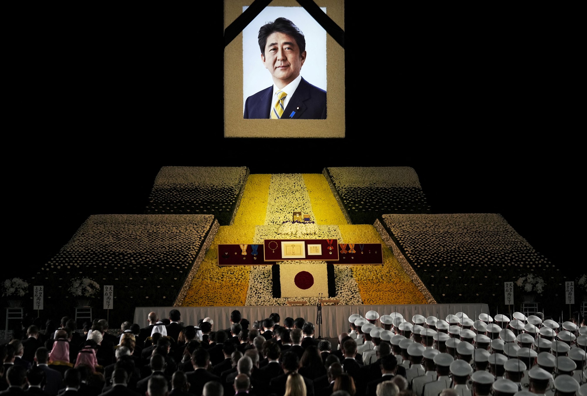 A portrait of former Japanese Prime Minister Shinzo Abe hangs on the stage during the state funeral of former Japanese Prime Minister Shinzo Abe at Nippon Budokan in Tokyo