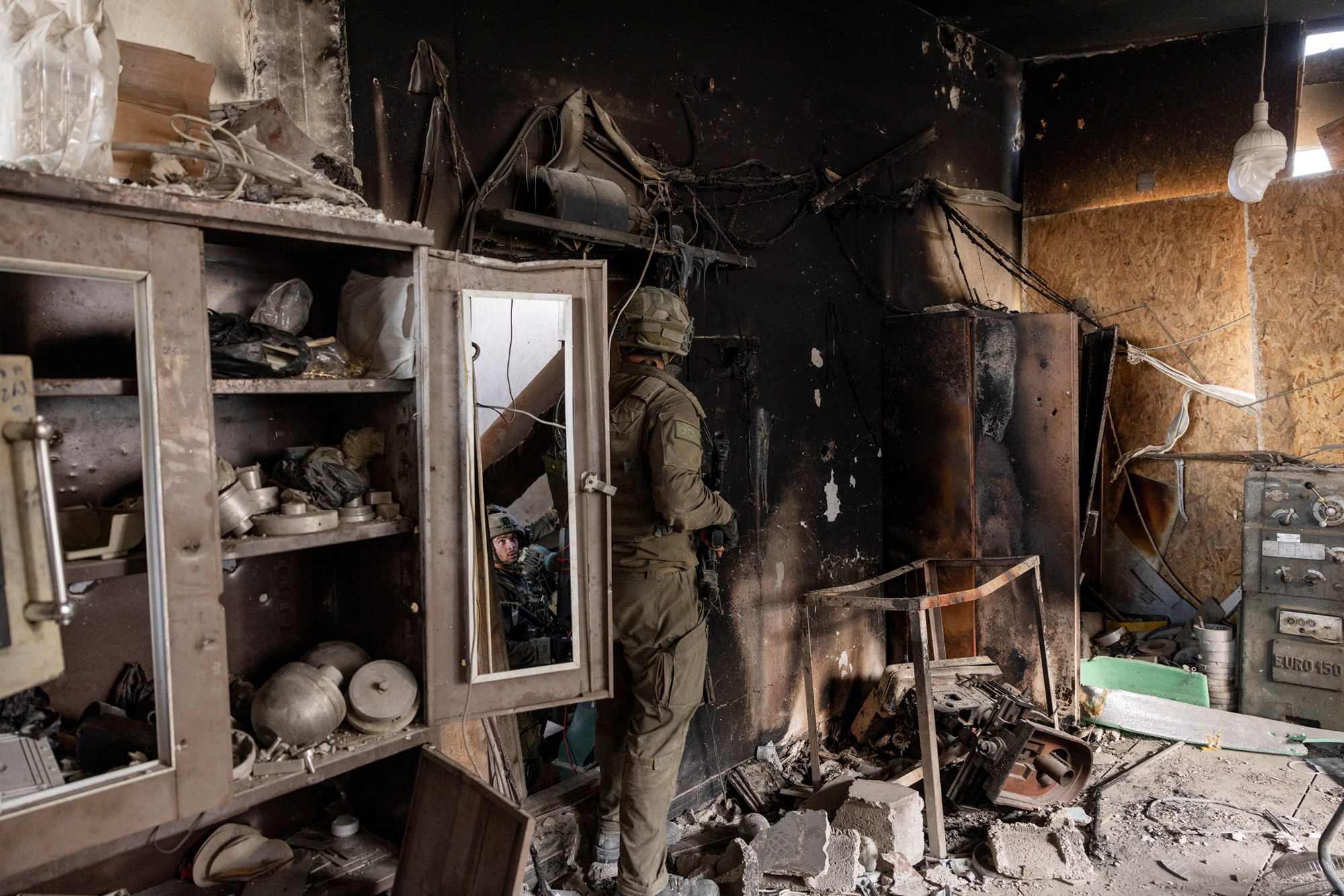 A soldier is pictured in what looks like a heavily damaged workshop