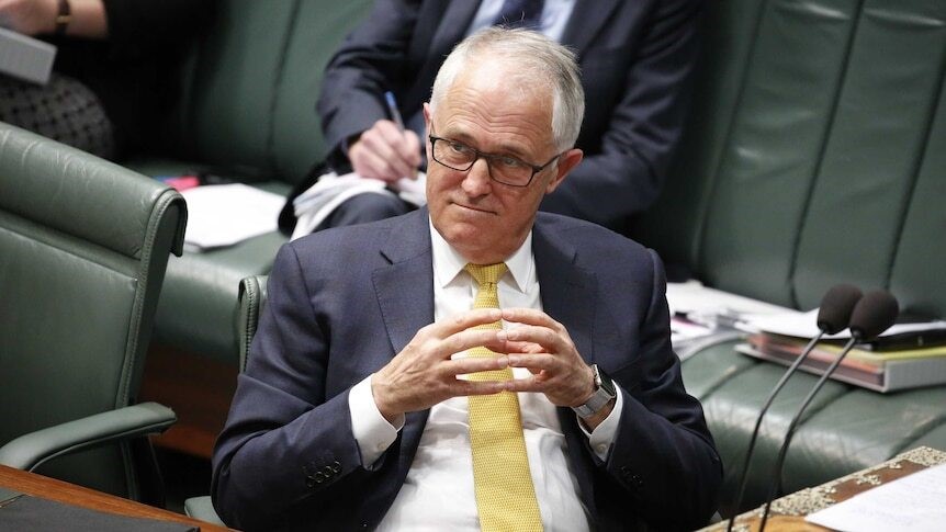 Turnbull sits and listens in parliament with his fingertips together, thinking.