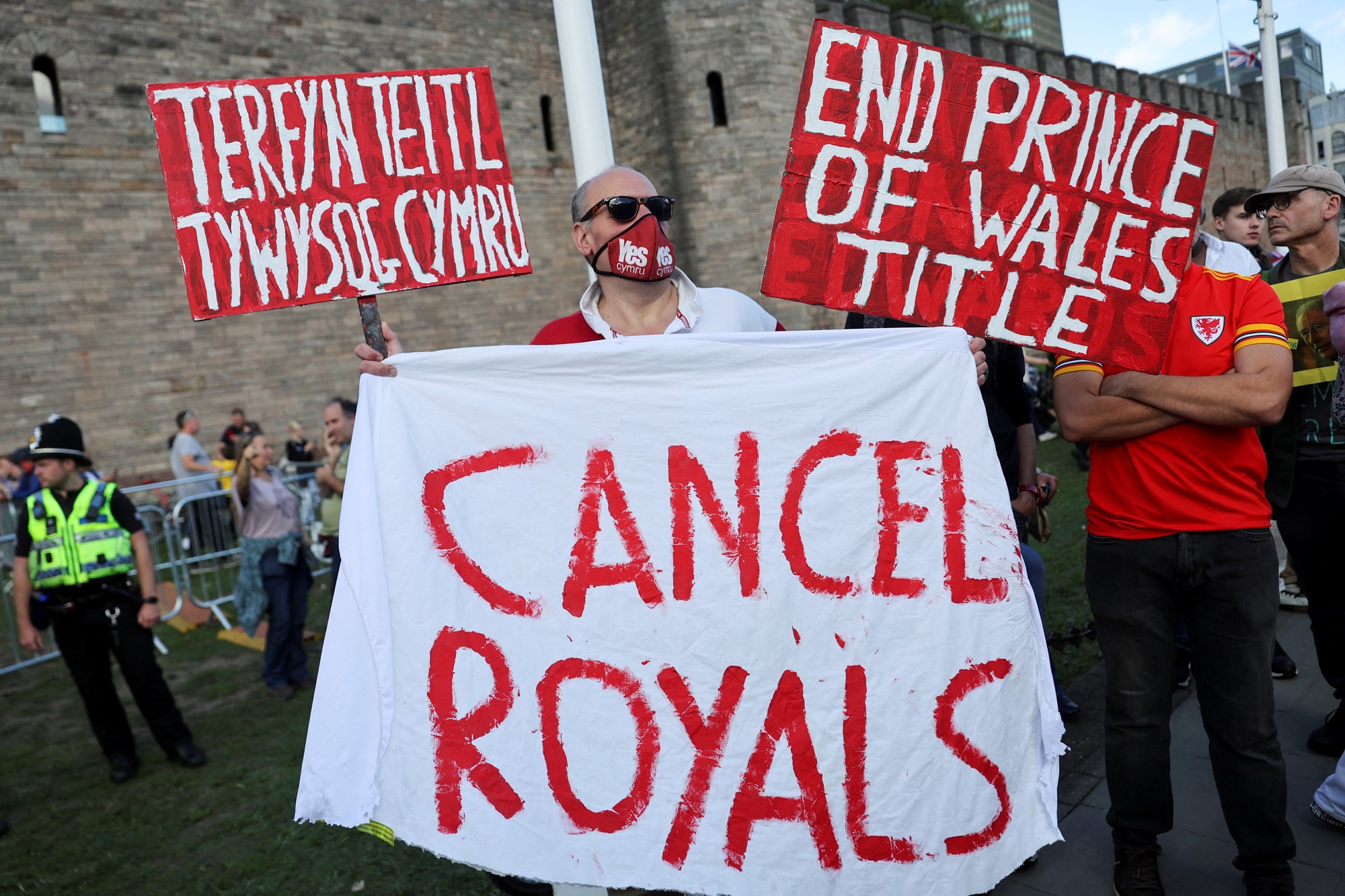 A man holding a sheet that reads "Cancel Royals"