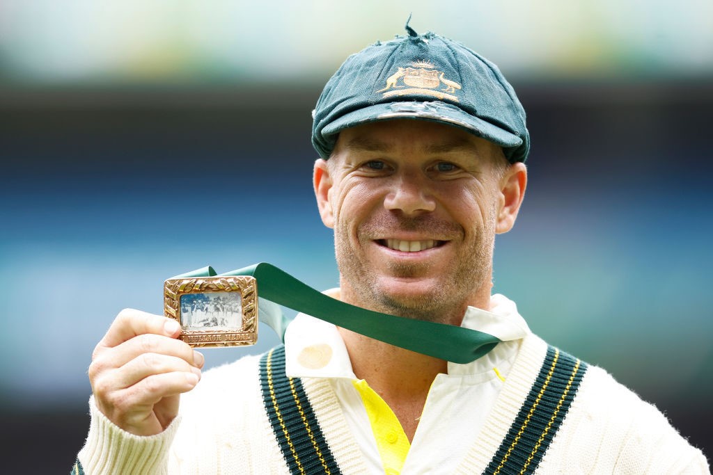 David Warner holds up the Johnny Mullagh Medal as player of the match in the Boxing Day Test against South Africa.