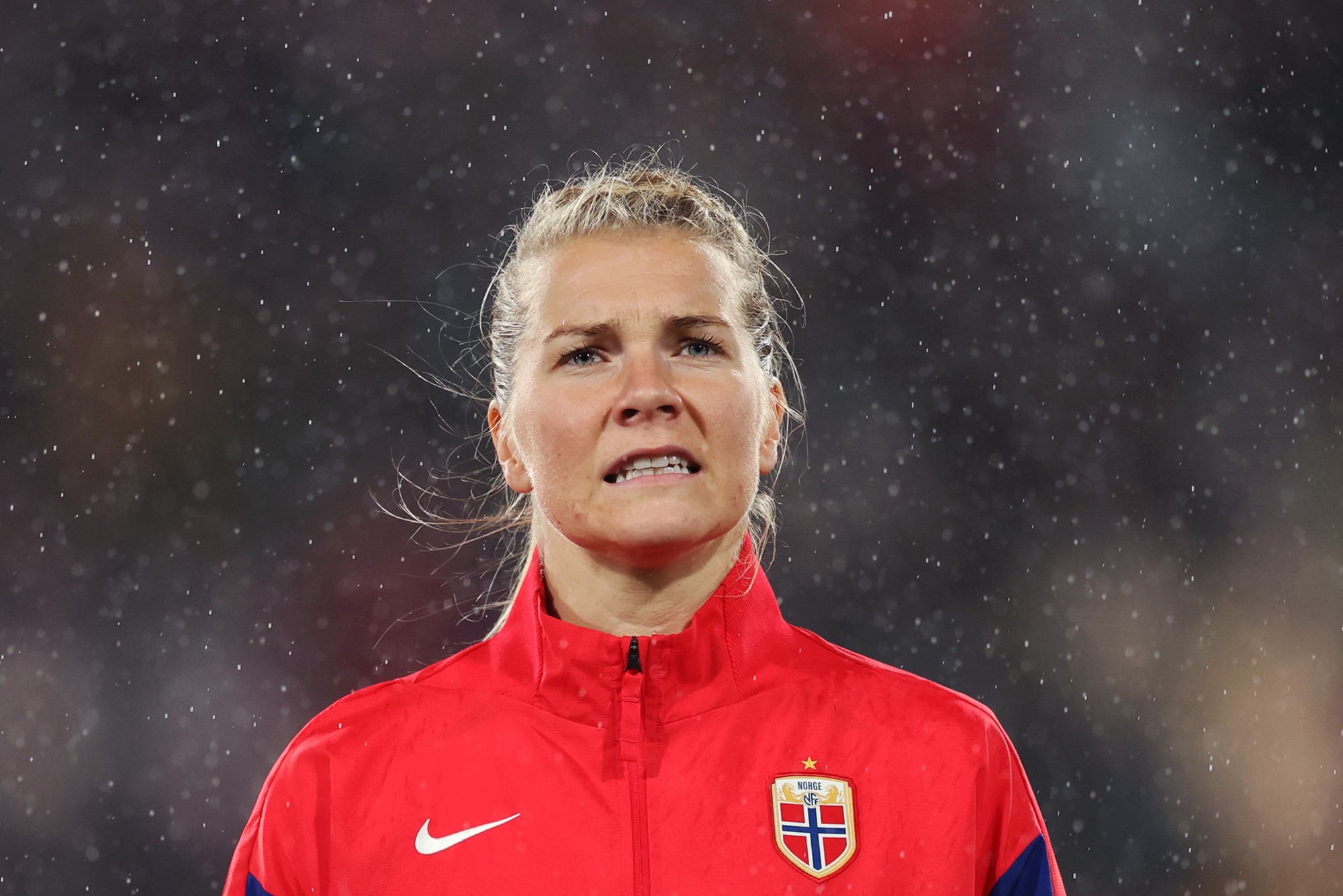 Norway's Ada Hegerberg stands in the rain in a red top at night before a FIFA Women's World Cup match