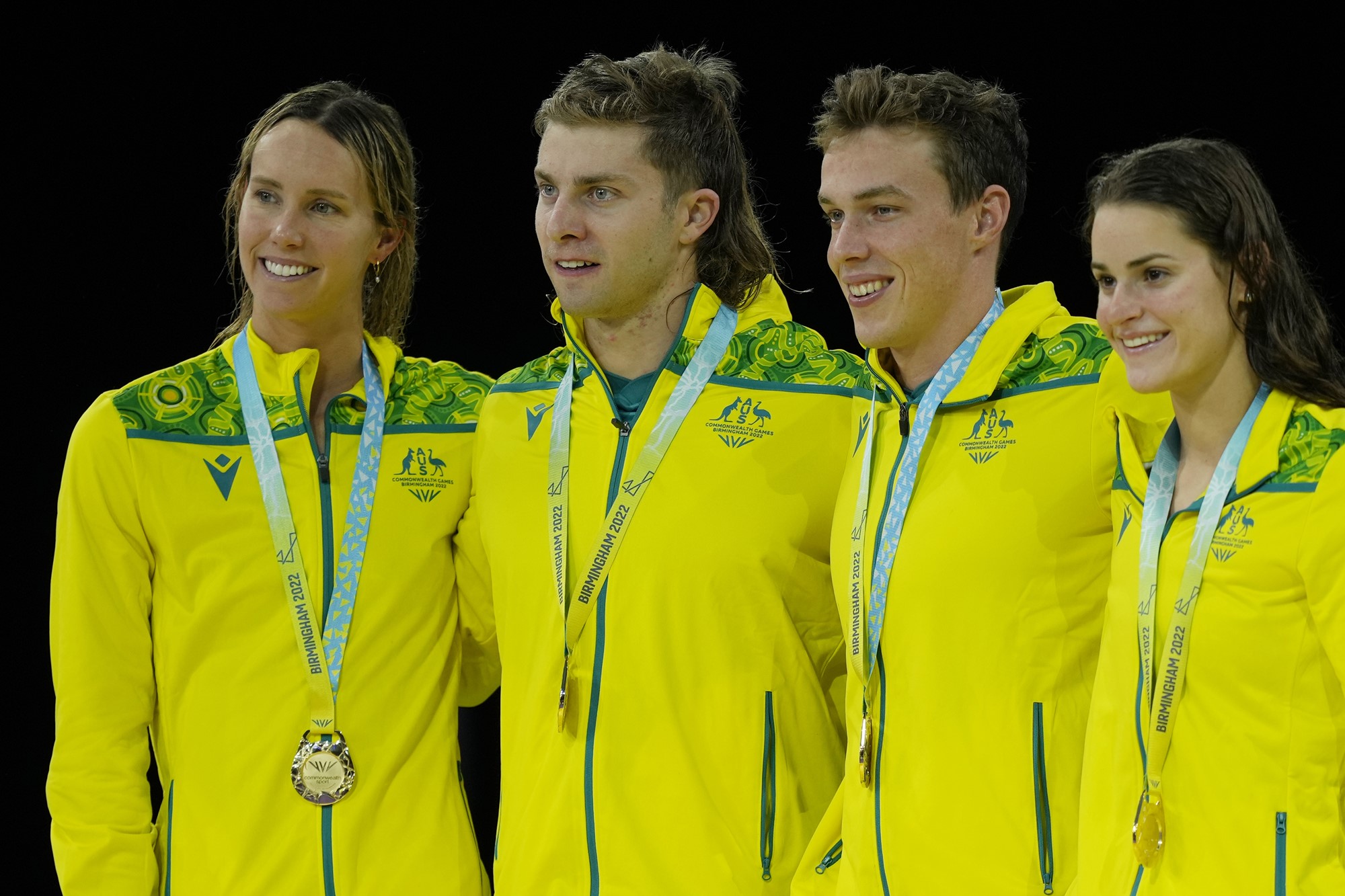 Australian swimmers Emma McKeon, Matthew Temple, Zac Stubblety-Cook and Kaylee McKeown wear their Commonwealth Games medals as they pose for a photo.