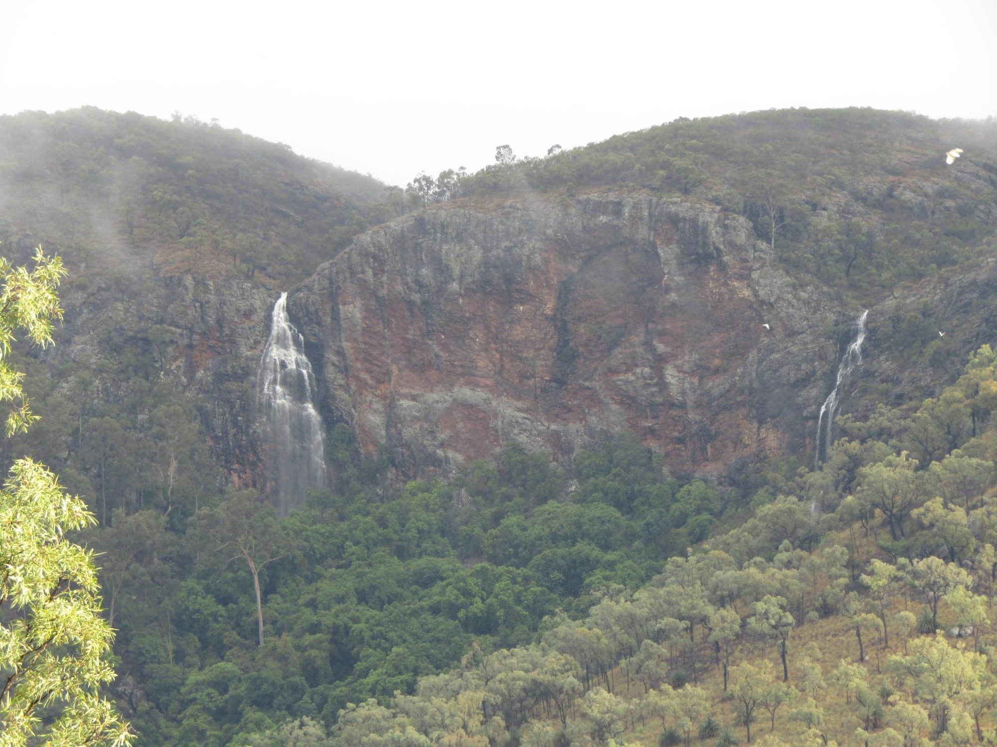Picture shows a waterfall on an overcast day.
