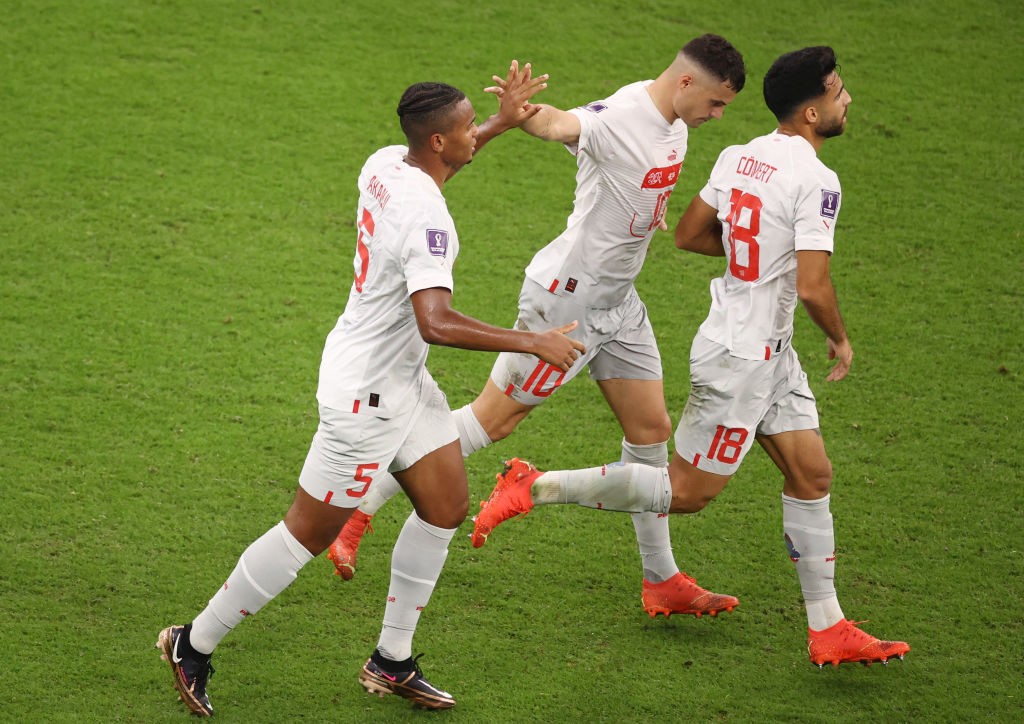 Manuel Akanji high-fives Switzerland teammates after a goal in the Qatar World Cup match against Portugal.