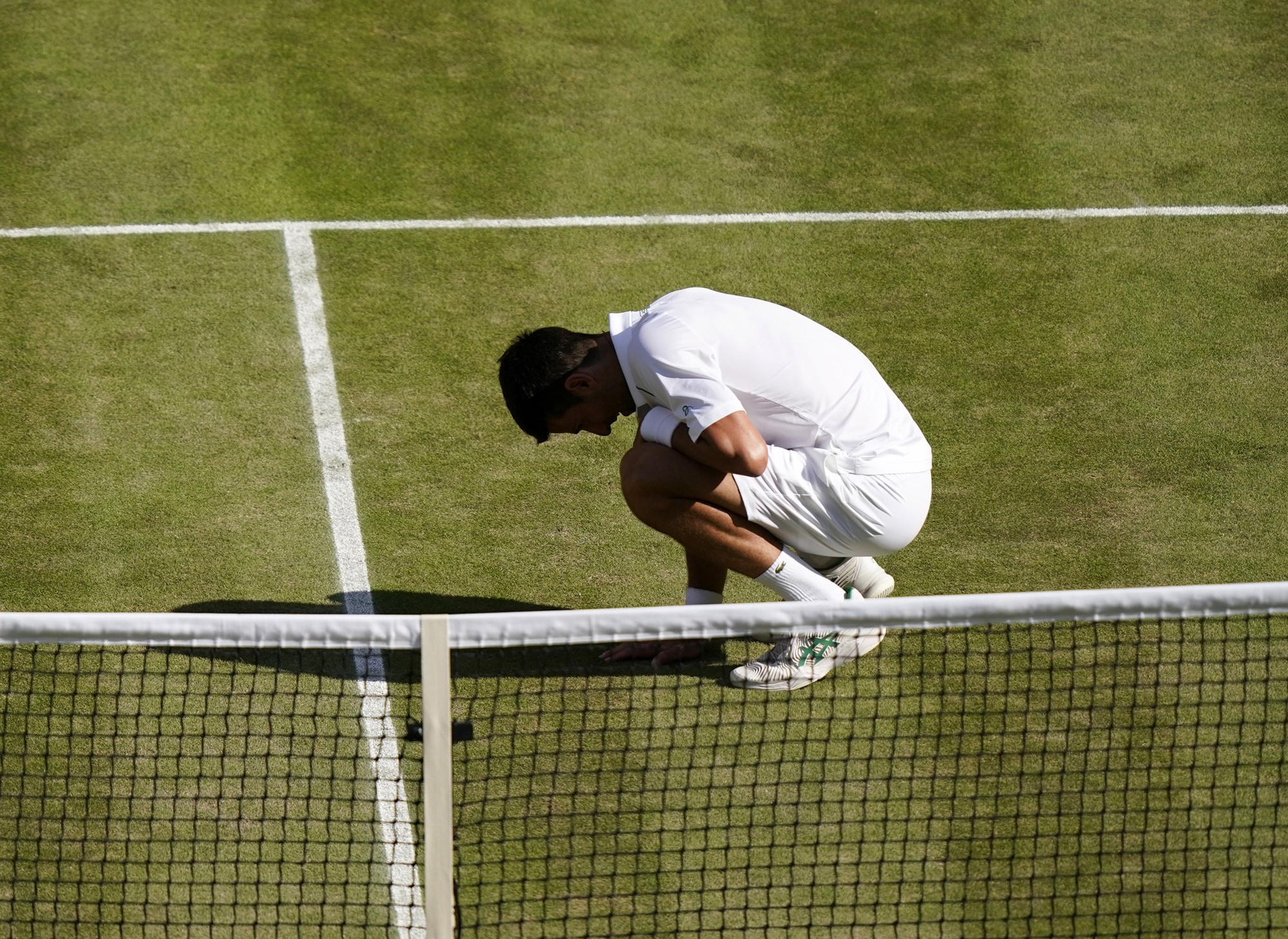 Novak Djokovic on his hanuches after winning the Wimbledon final.