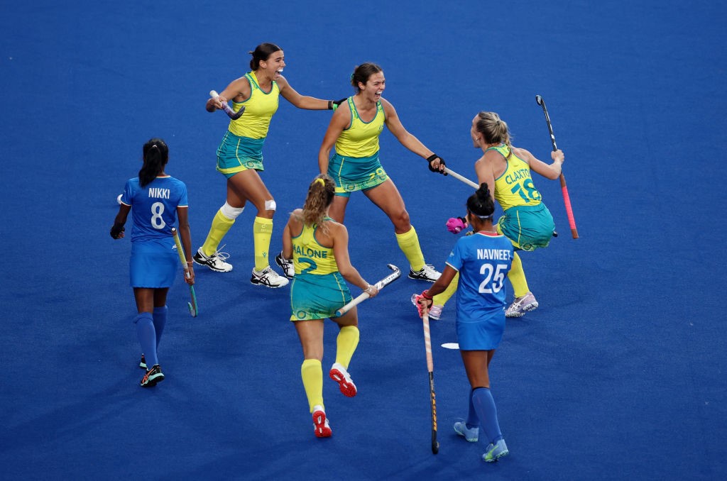 Australian hockey players celebrate a goal against India at the Commonwealth Games.