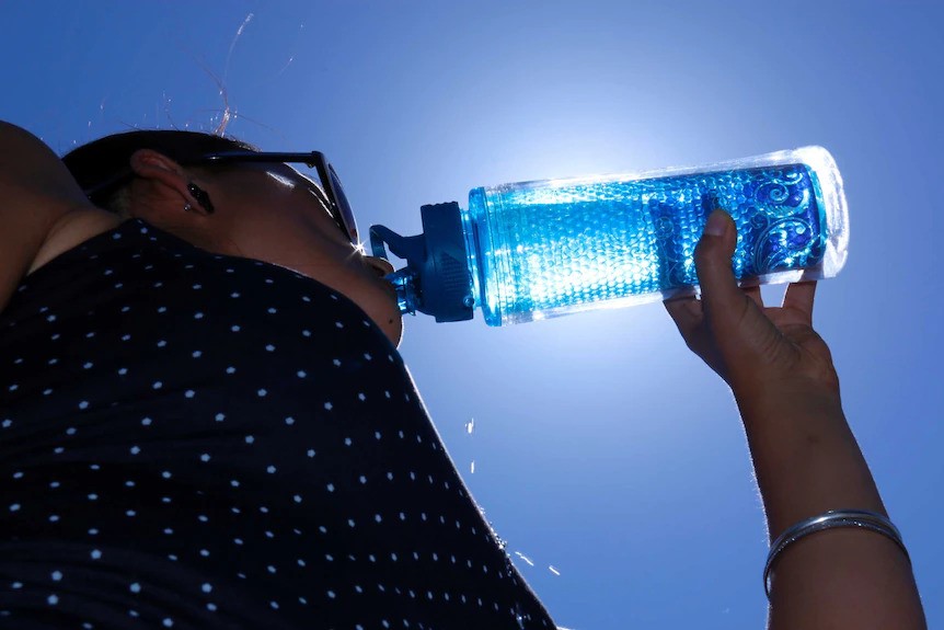 A person drinking from a water bottle