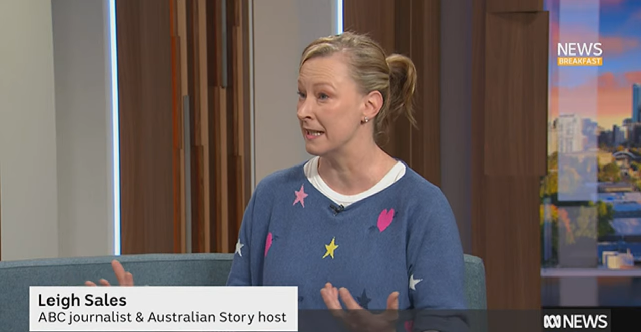A woman in a jumper with stars on it sits on a TV breakfast show couch and speaks during an interview