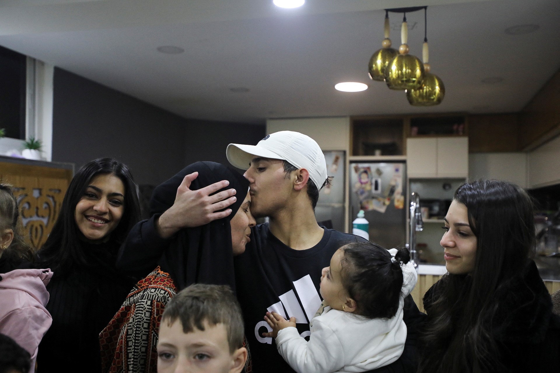 A released Palestinian prisoner is received by his family in his hous