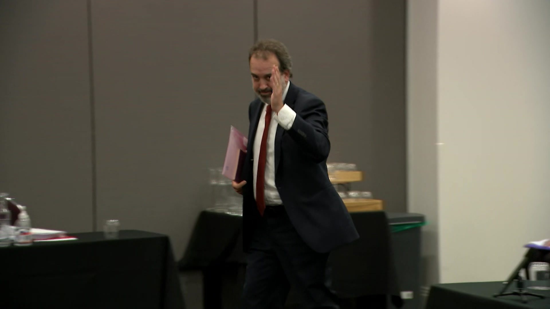 Martin Pakula salutes as he leaves the hearing.