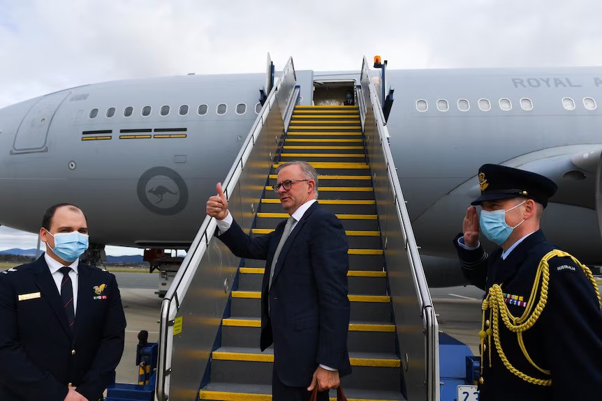 Anthony Albanese gives a thumbs up as he boards an RAAF plane.