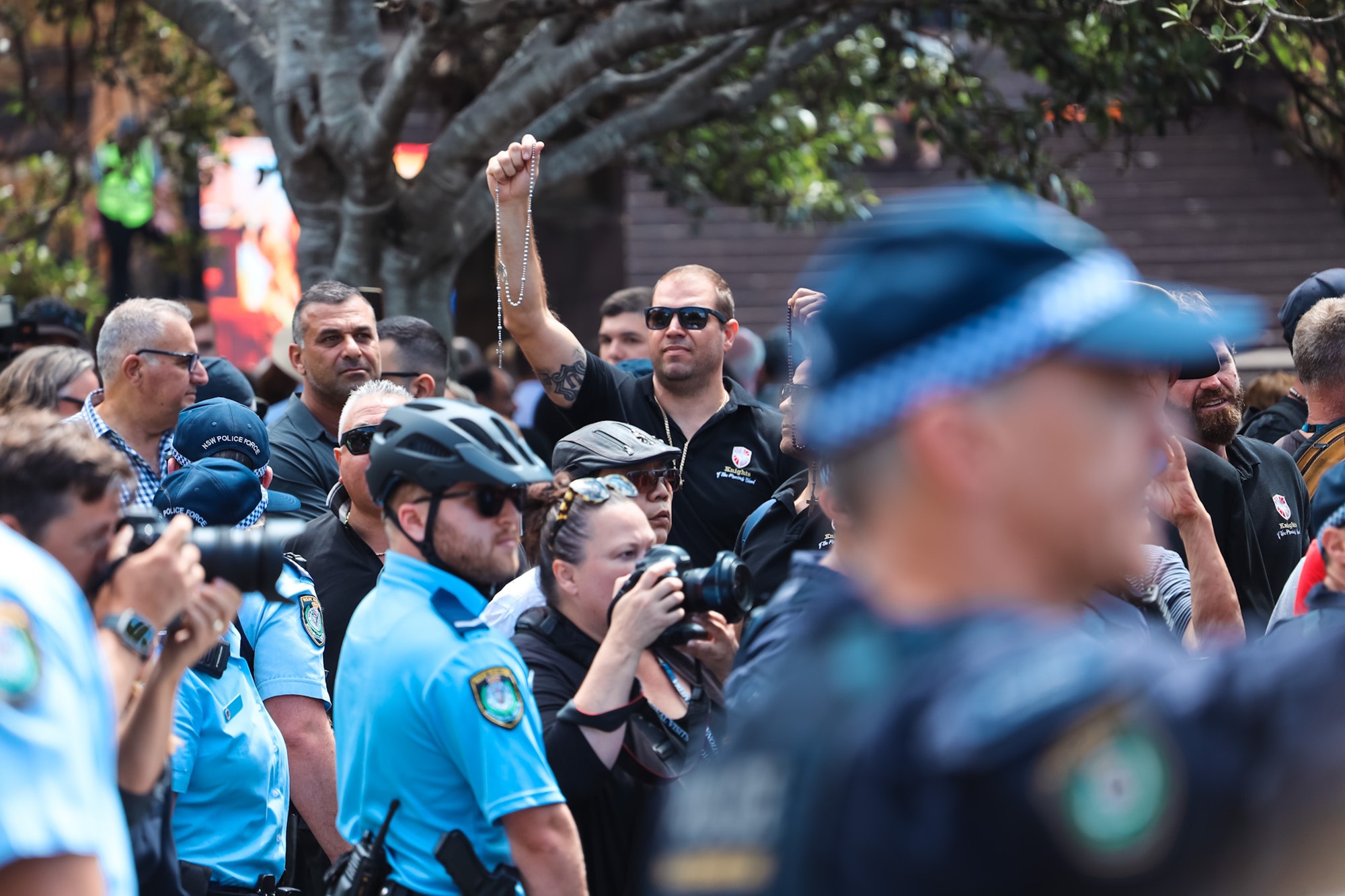 Police stand in front of protesters