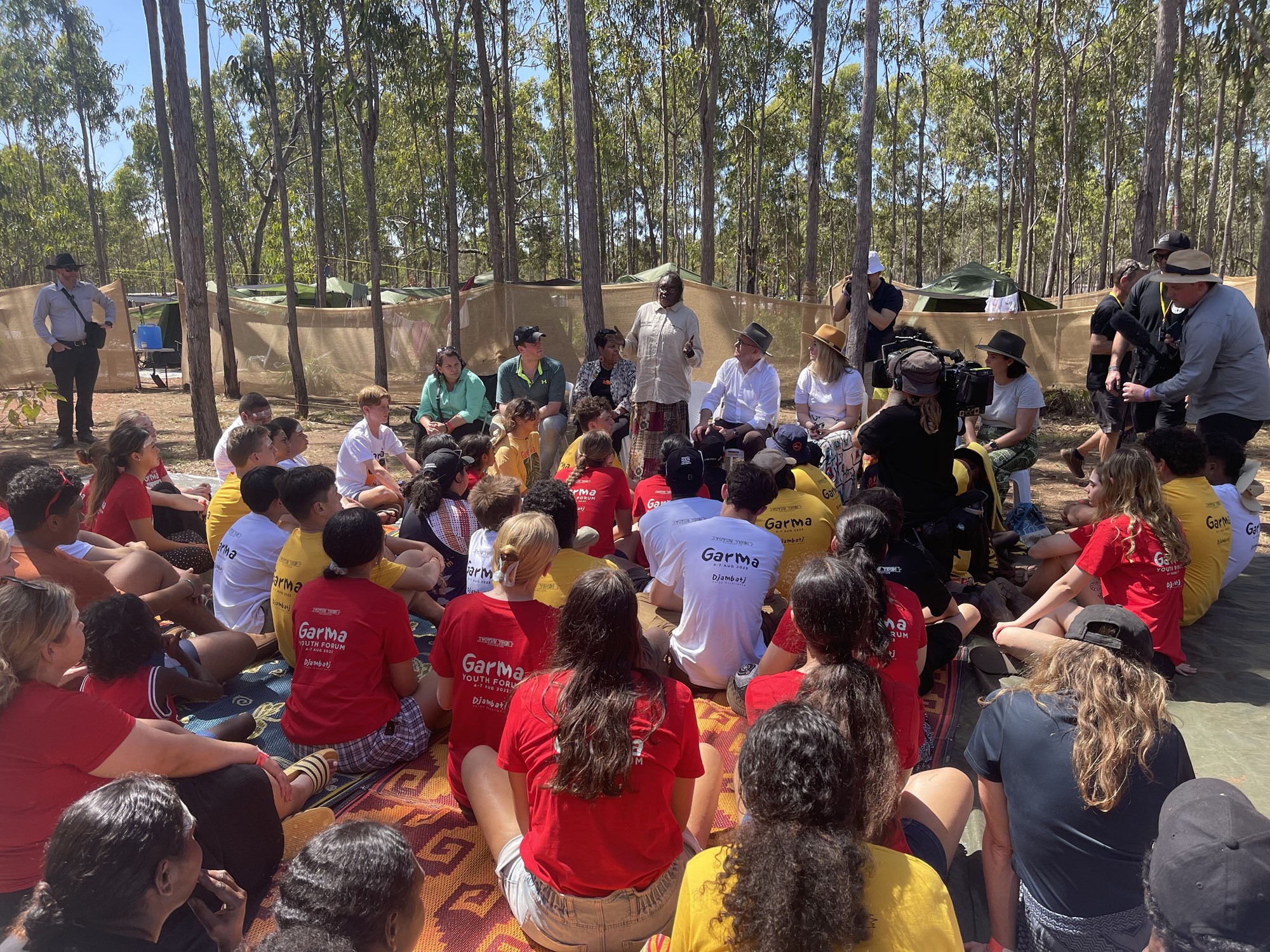 The prime minister sits in front of a group of young Indigenous leaders.