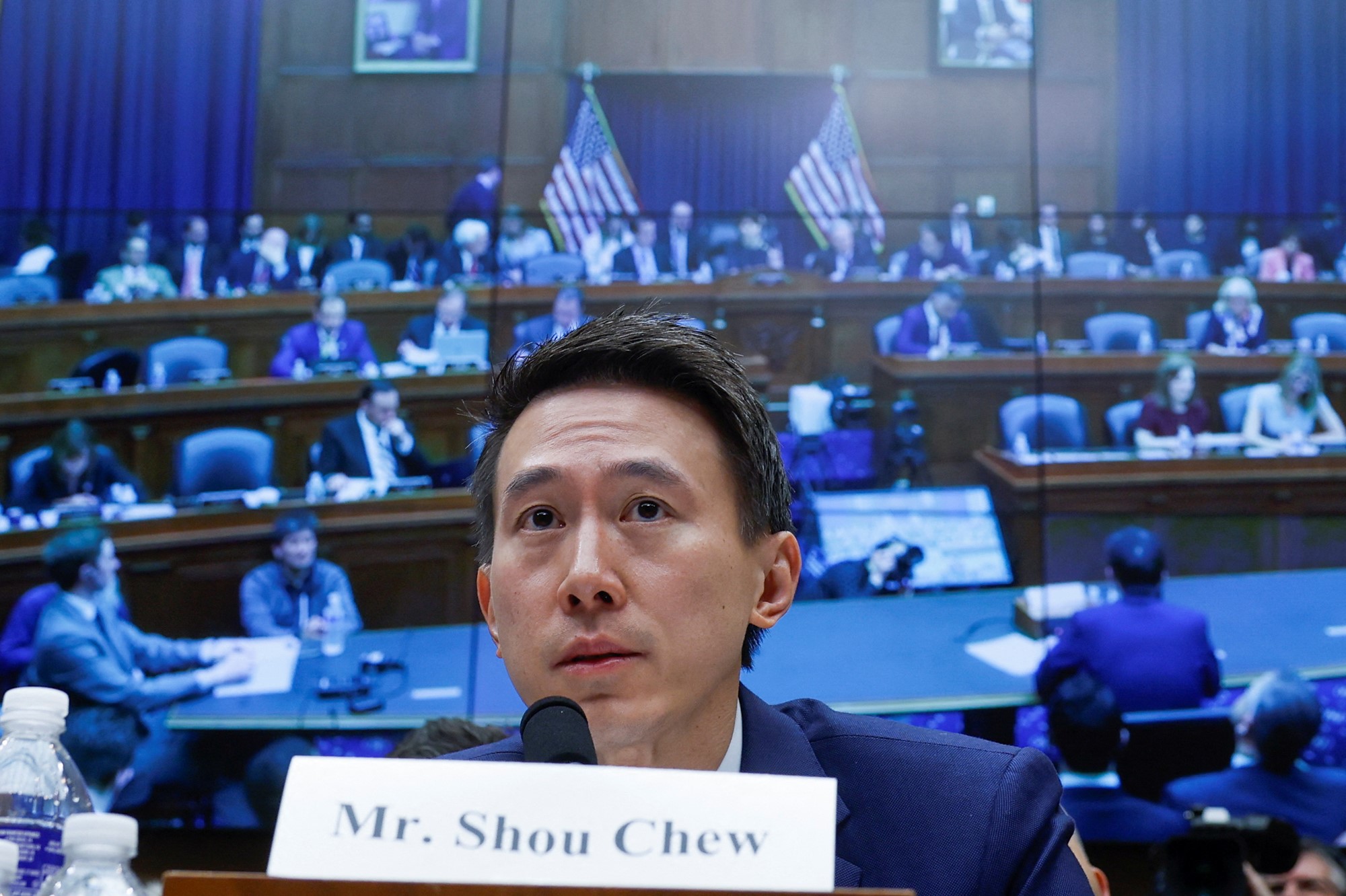 A man sits before a committee.