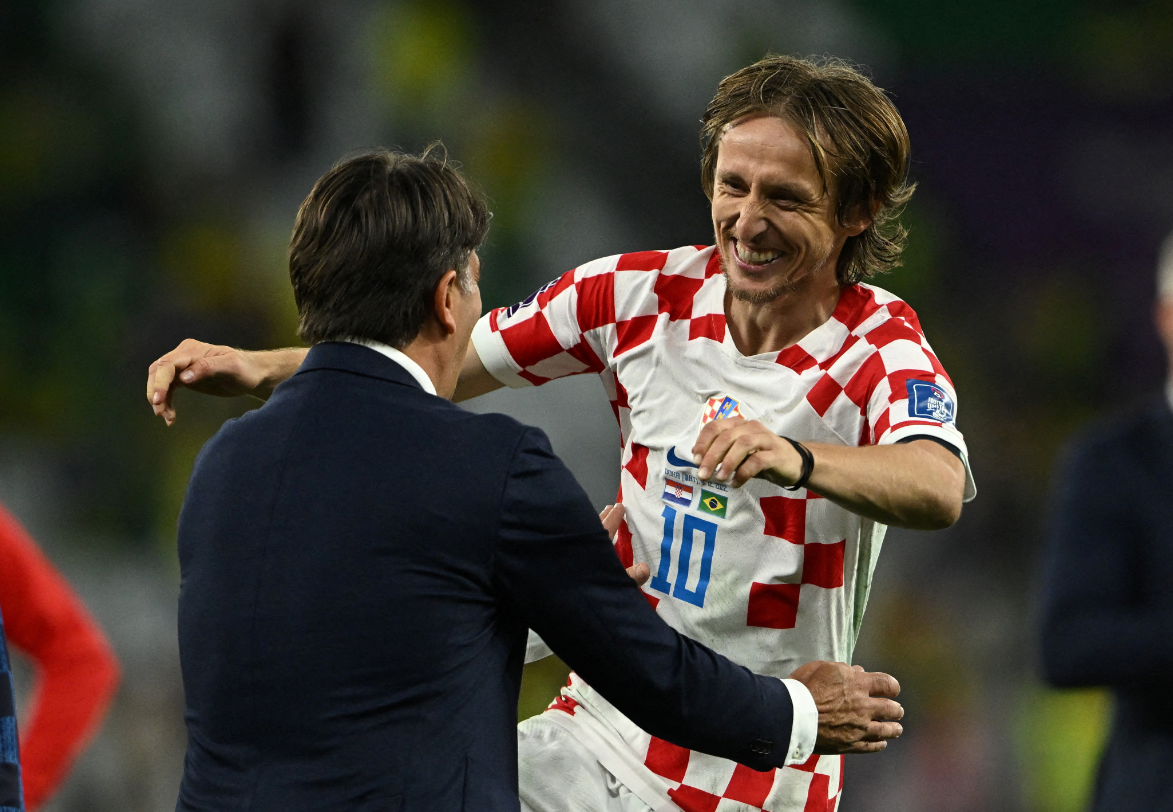Croatia's Luka Modric jumps into his coach's arms after beating Brazil at the FIFA World Cup in Qatar.