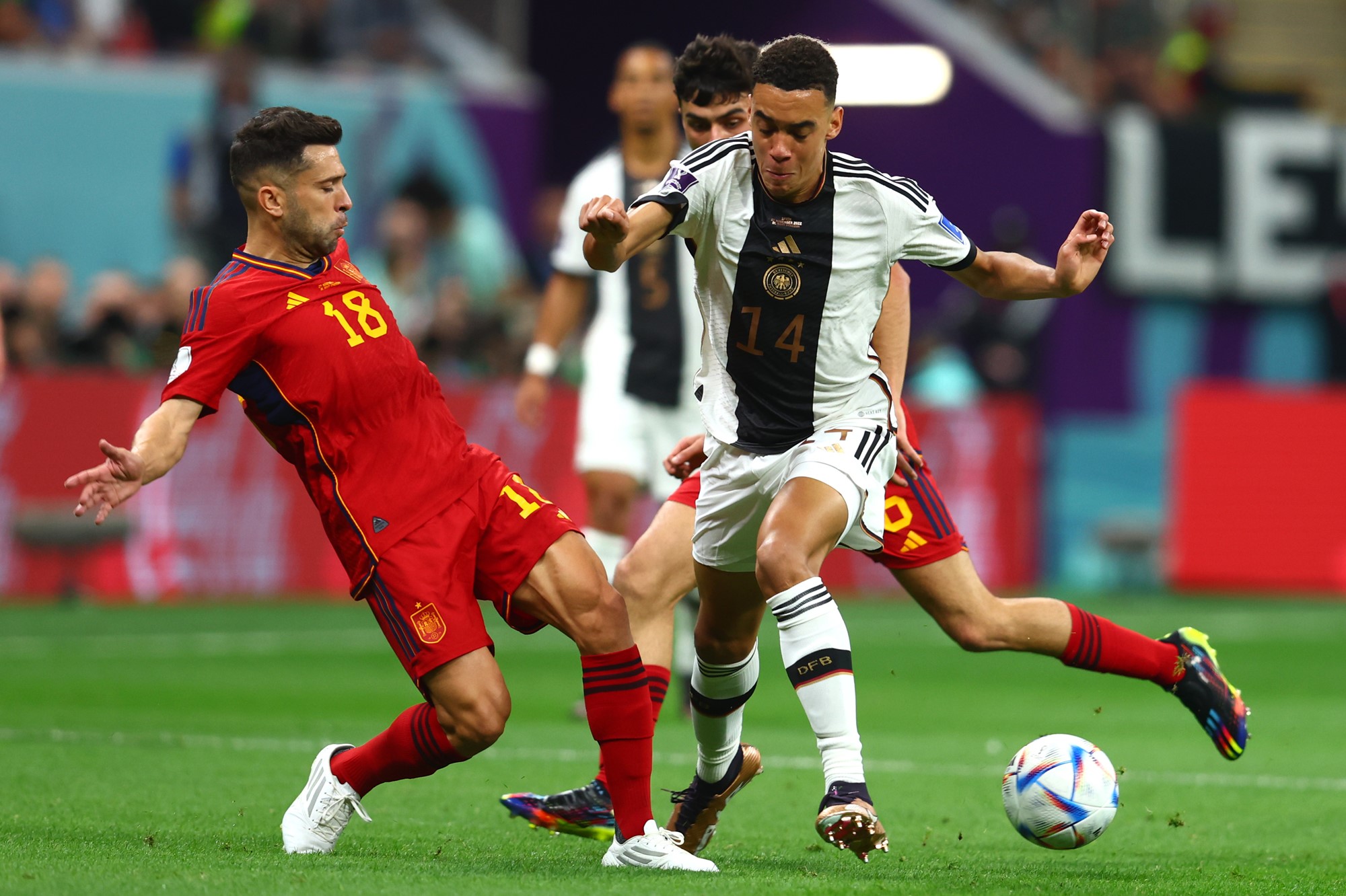 Spaniard Jordi Alba competes for the ball with Germany's Jamal Musiala.