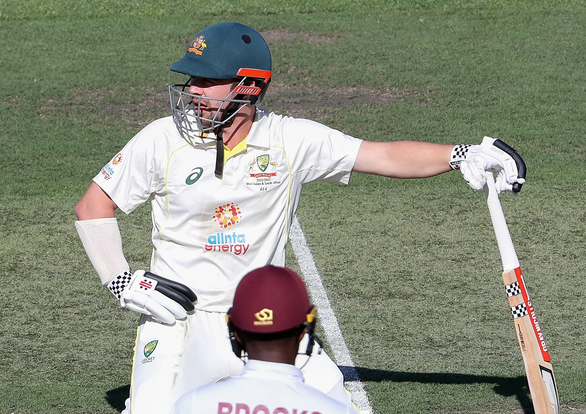 Australia batter Travis Head looks miserable on his knees during a cricket Test against West Indies.