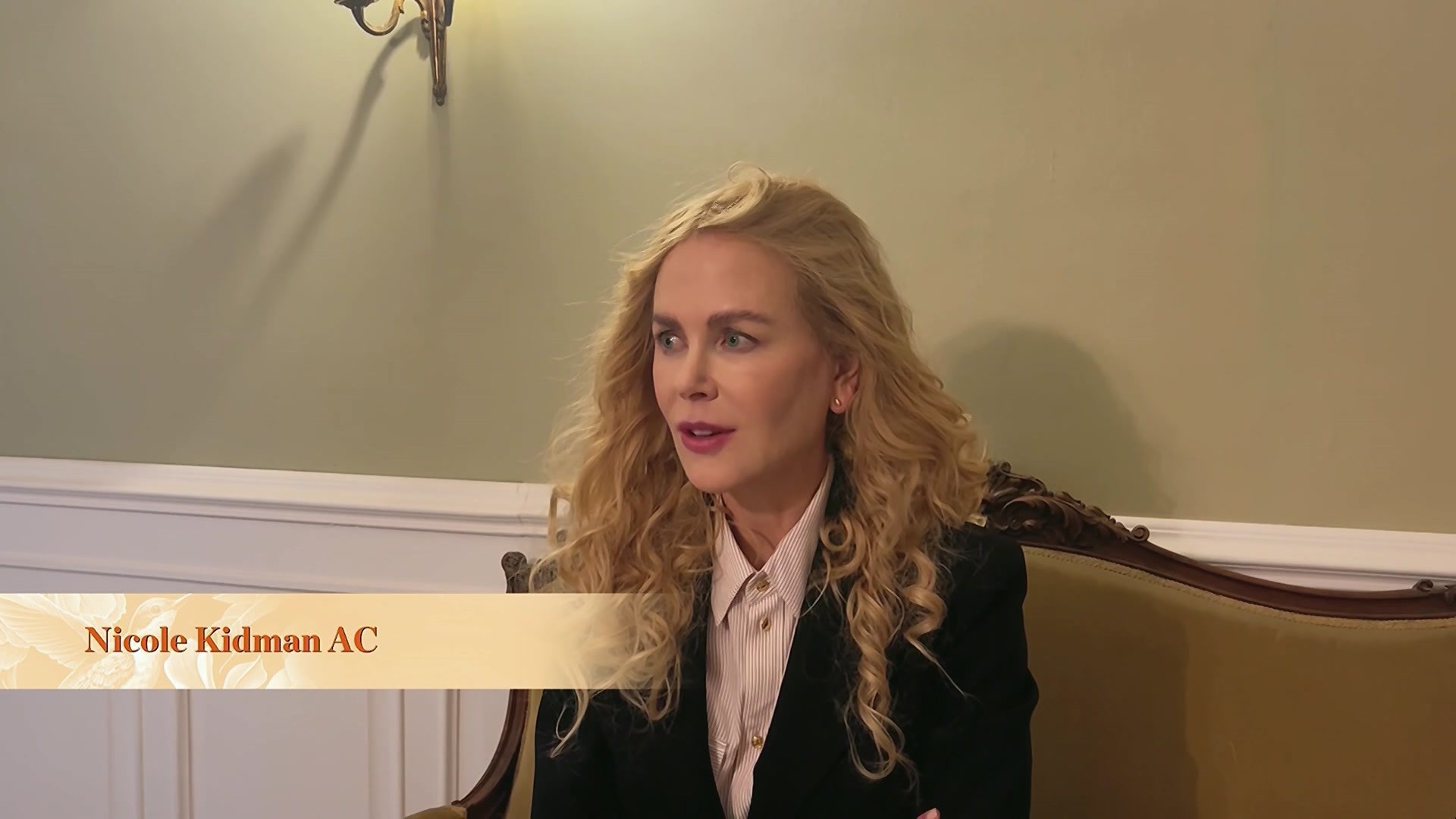 Nicole Kidman speaks on a couch.