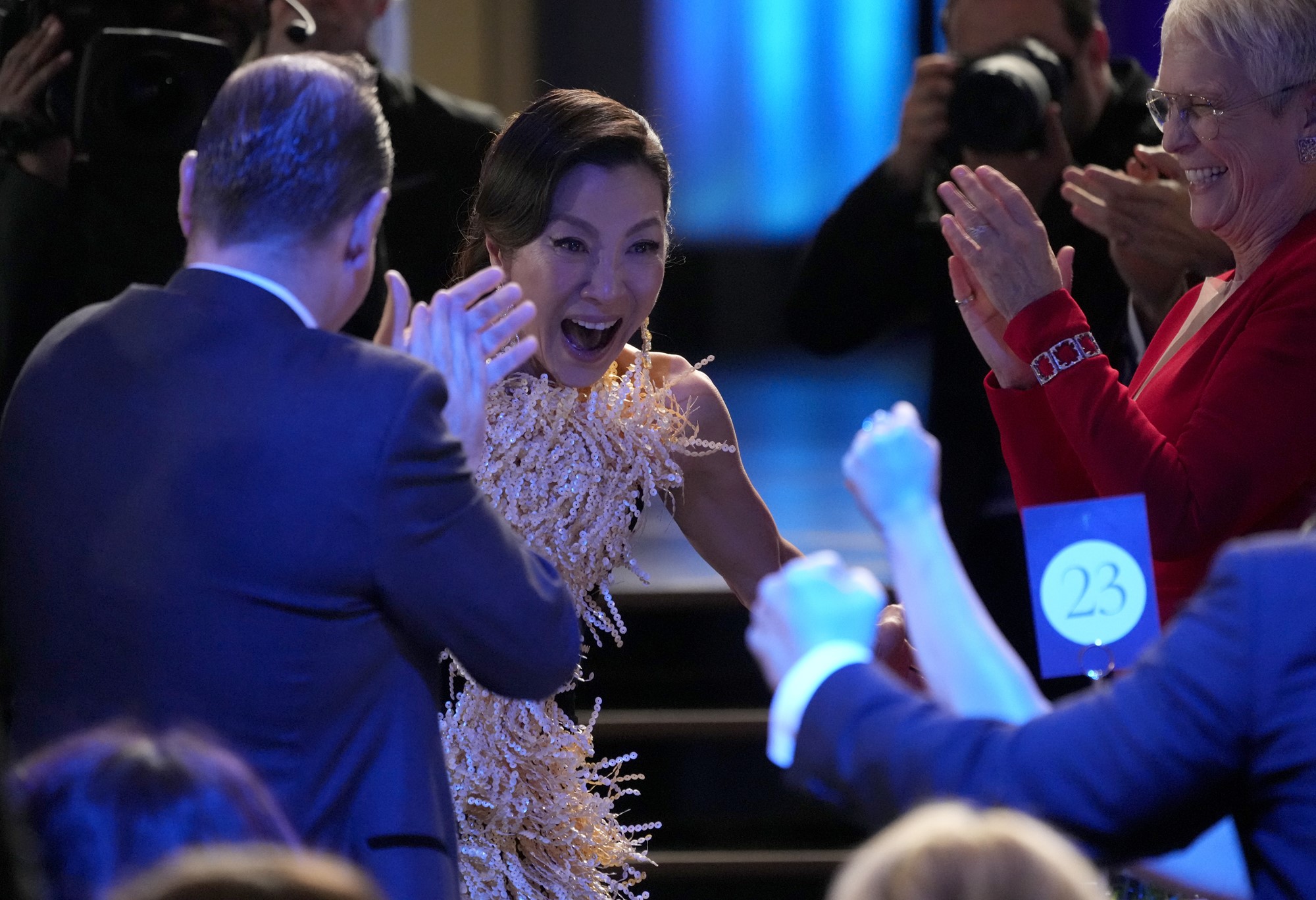 Michelle reacts as co-stars clap.