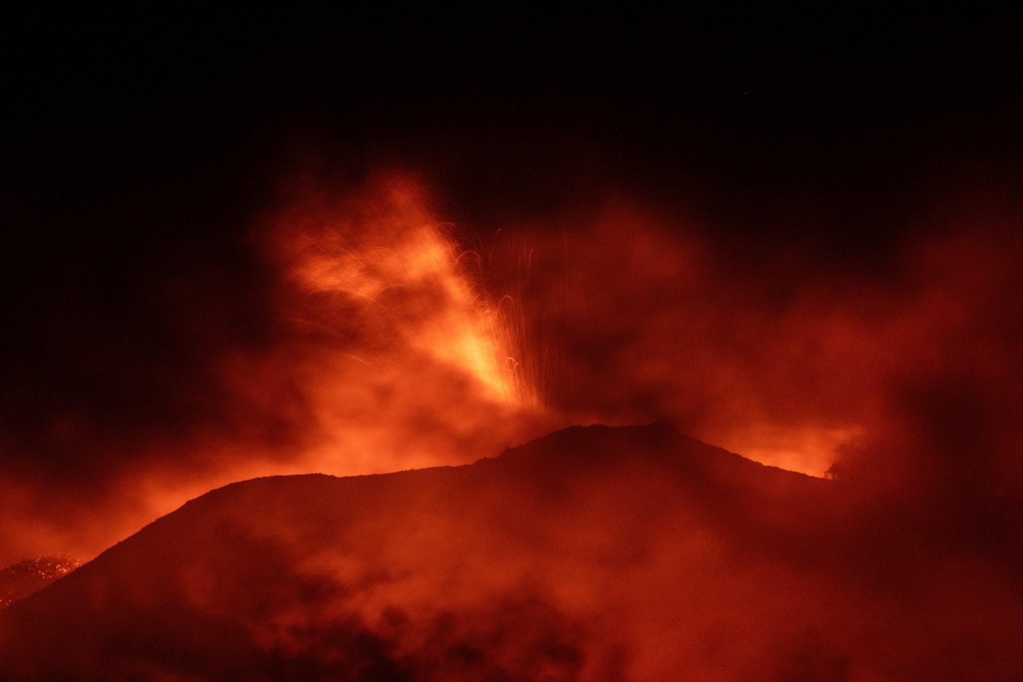 Red fire and ash coming out of a volcano