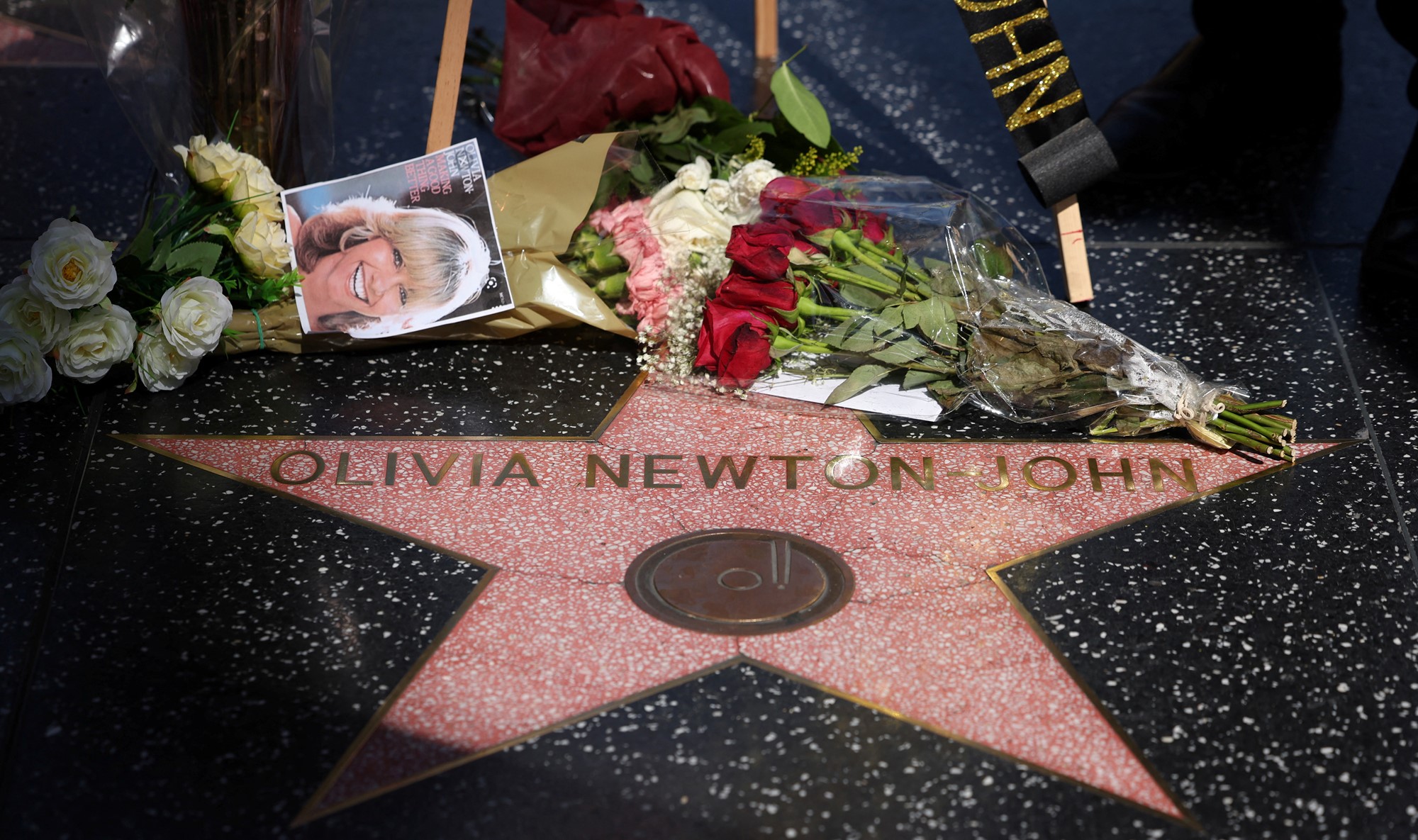 Flowers are left next to Olivia Newton-John's star on the walk of fame.