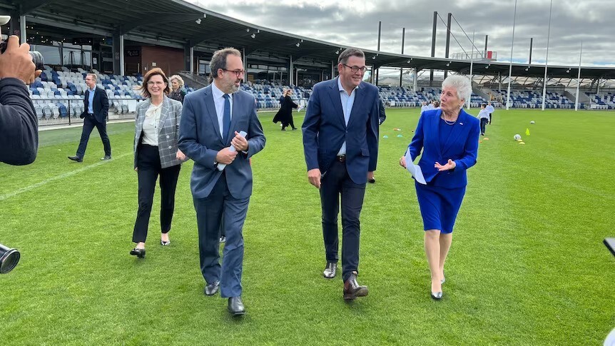 Premier Daniel Andrews with Martin Pakula on an oval.