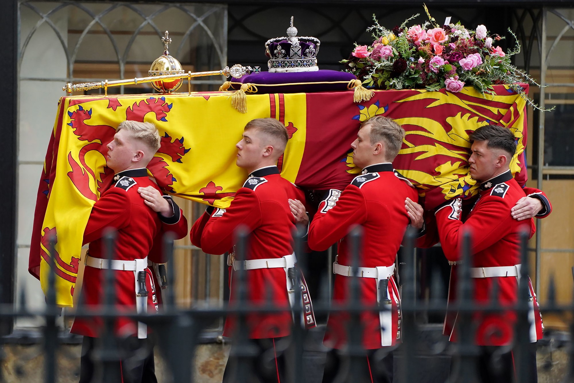 Four pall bearers carry the Queen's coffin