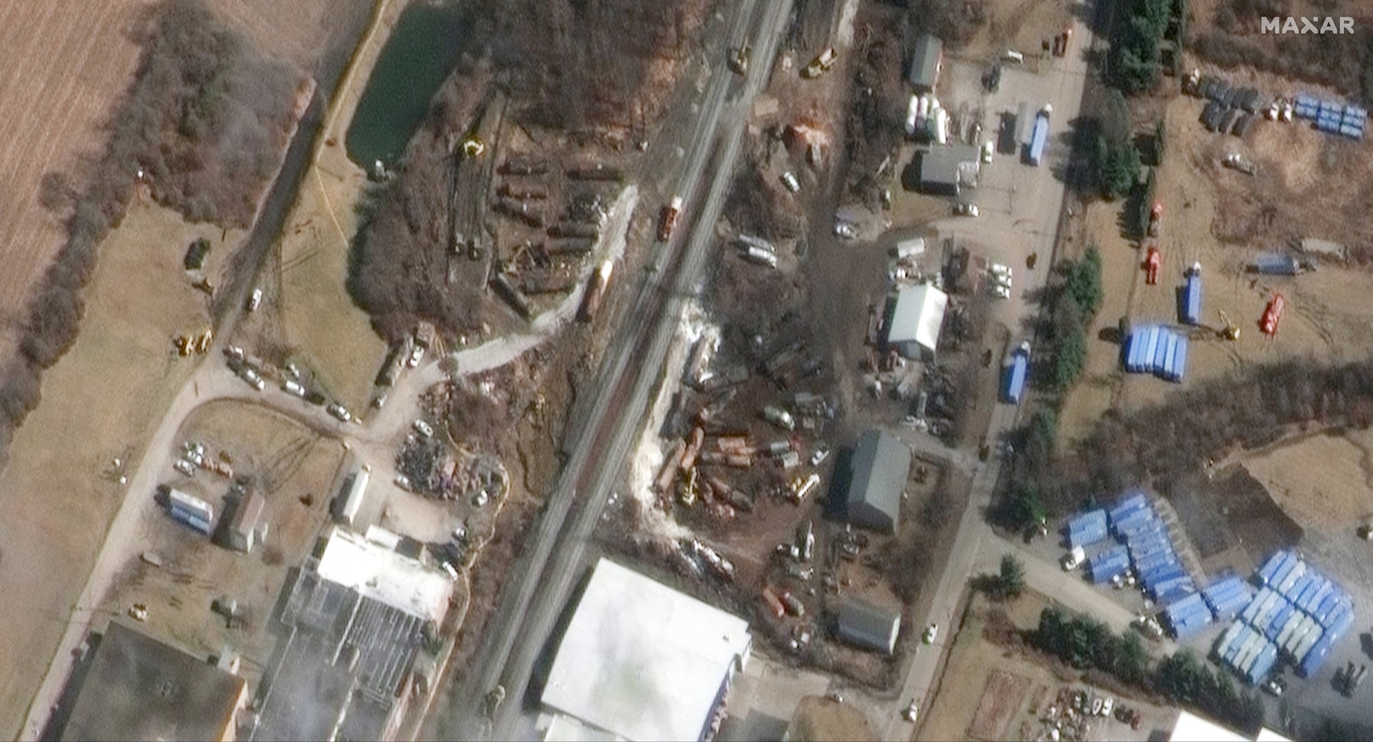 A satellite imag of a train yard where much of the ground has been burned. 