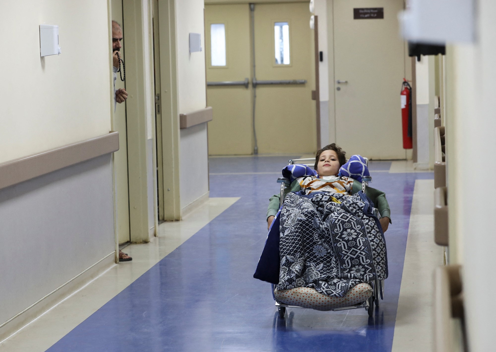 A boy in a hospital in a wheelchair. 