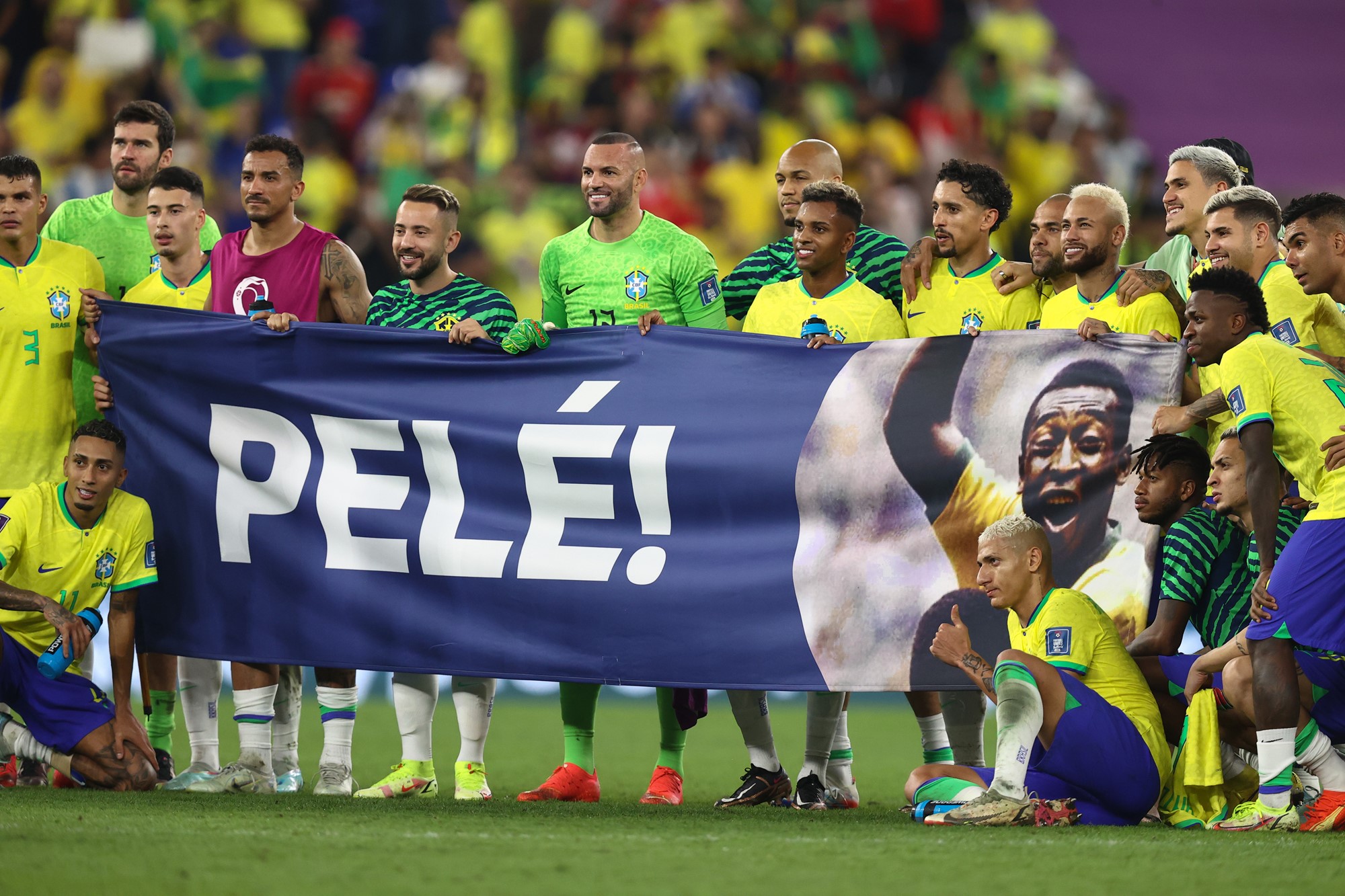 Brazil players hold up a banner reading Pelé after beating South Korea at the Qatar FIFA World Cup.