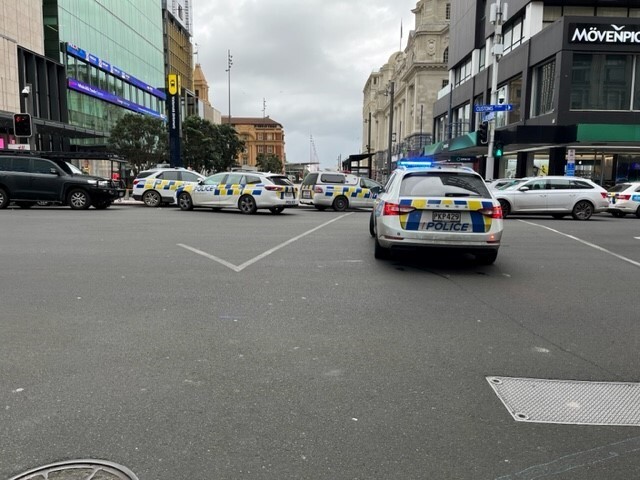 a sectioned off street and police cars