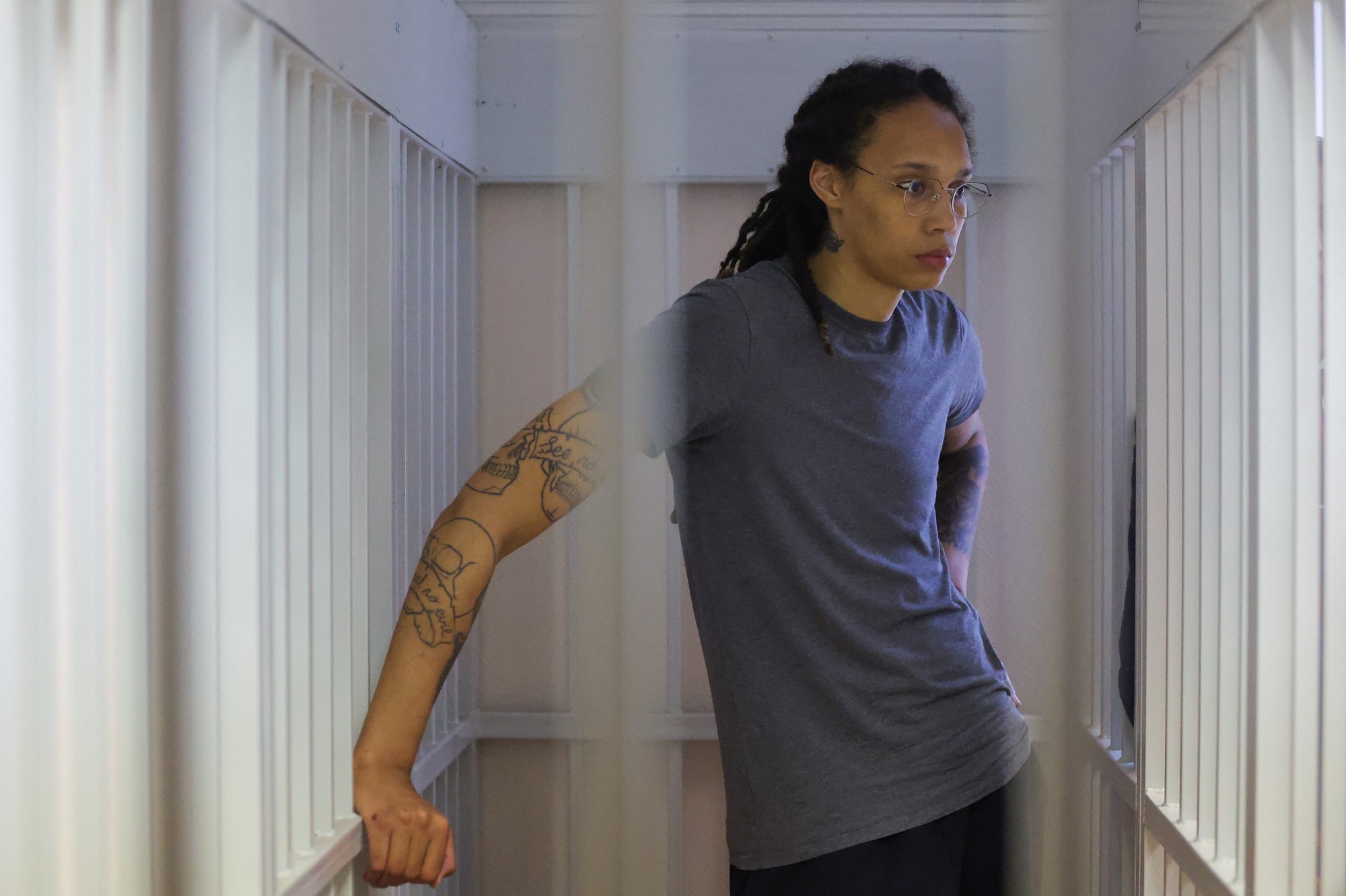 Brittney Griner stands in a small cell