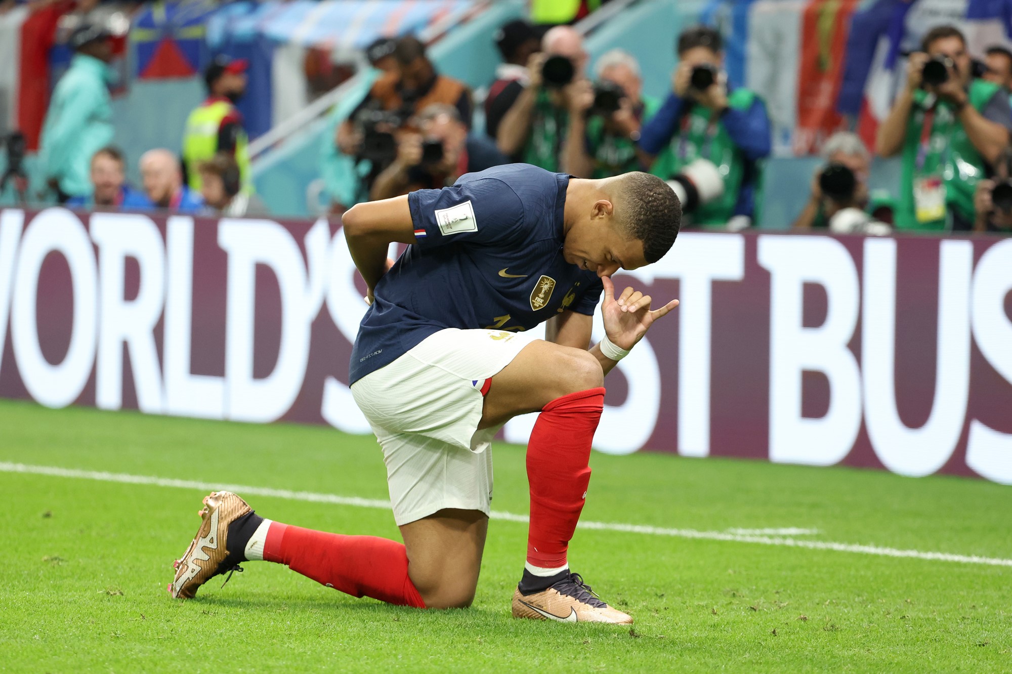 Mbappe kneels and puts his thumb to his nose