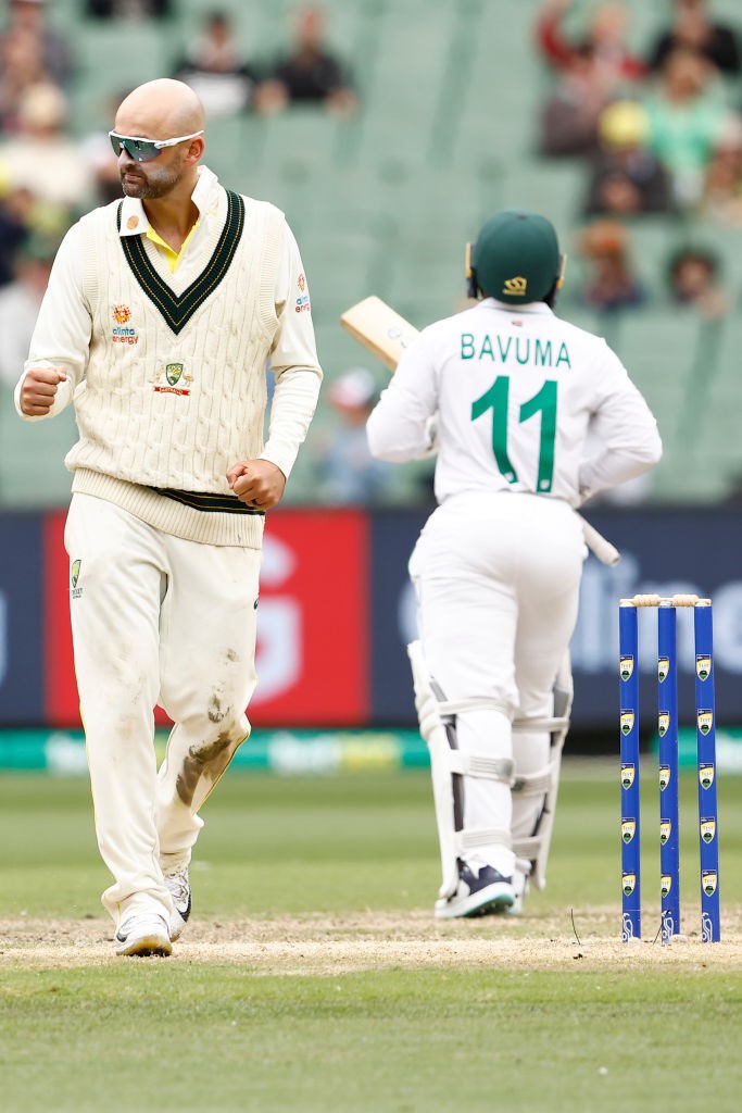 Australia bowler Nathan Lyon clenches his fist as South Africa batter Temba Bavuma walks off during a Test.
