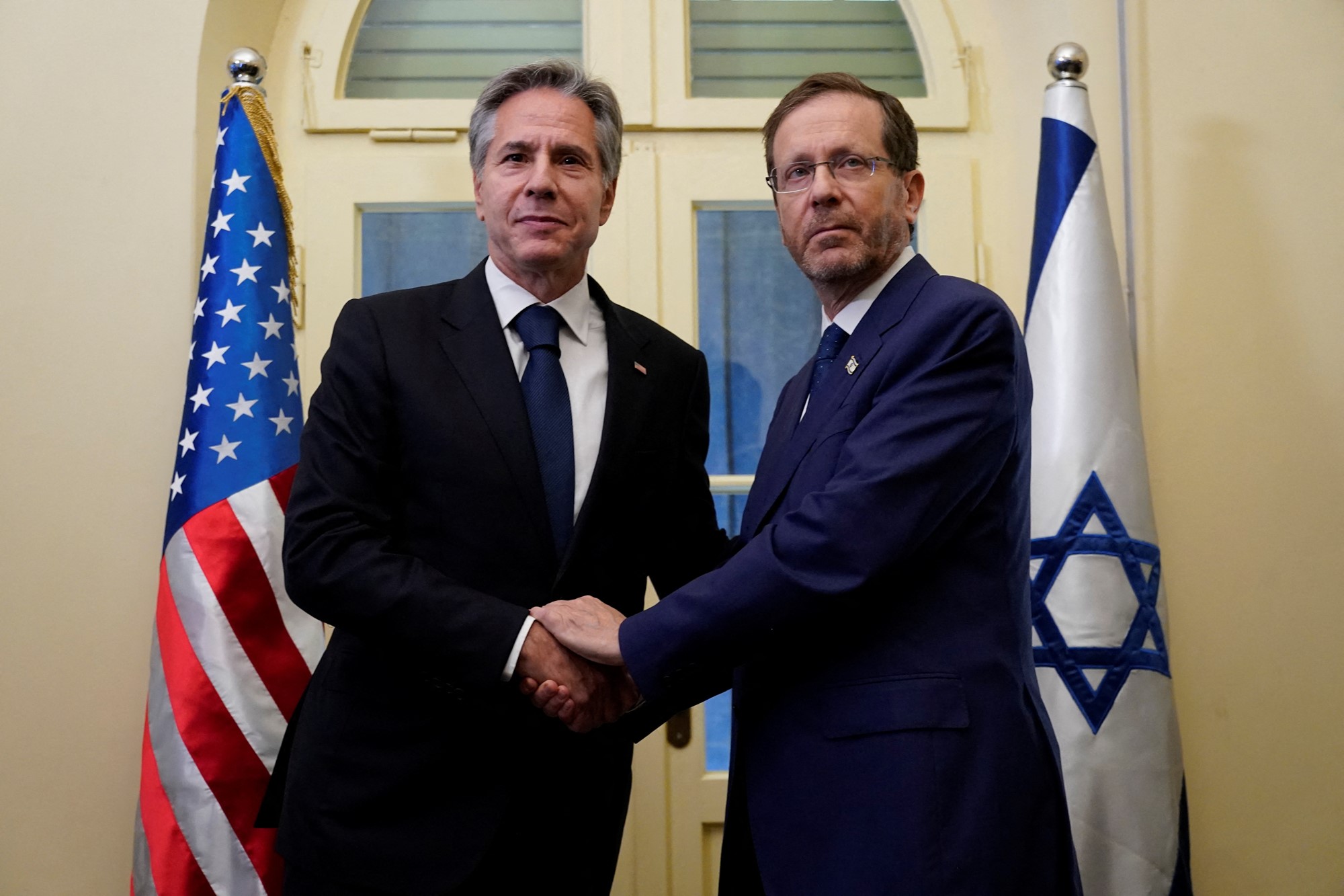 U.S. Secretary of State Antony Blinken and Israel's President Isaac Herzog shake hands