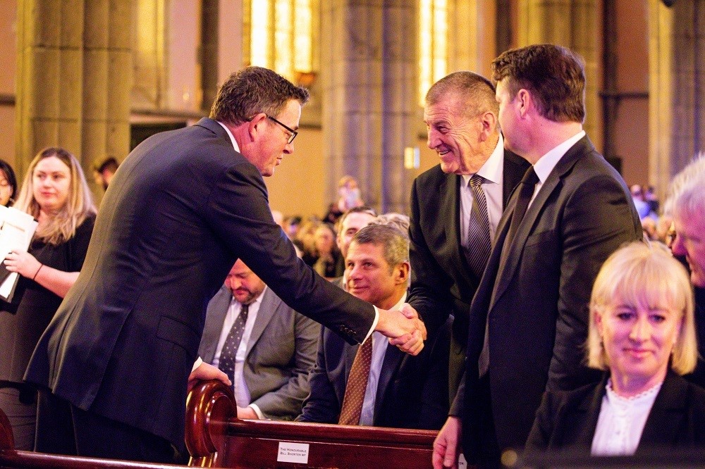 Daniel Andrews and Jeff Kennett exchange a greeting at the state funeral for Father Bob Maguire.