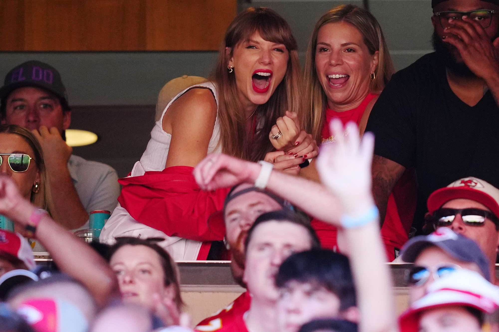 Taylor screams in delight in the crowd with another woman.