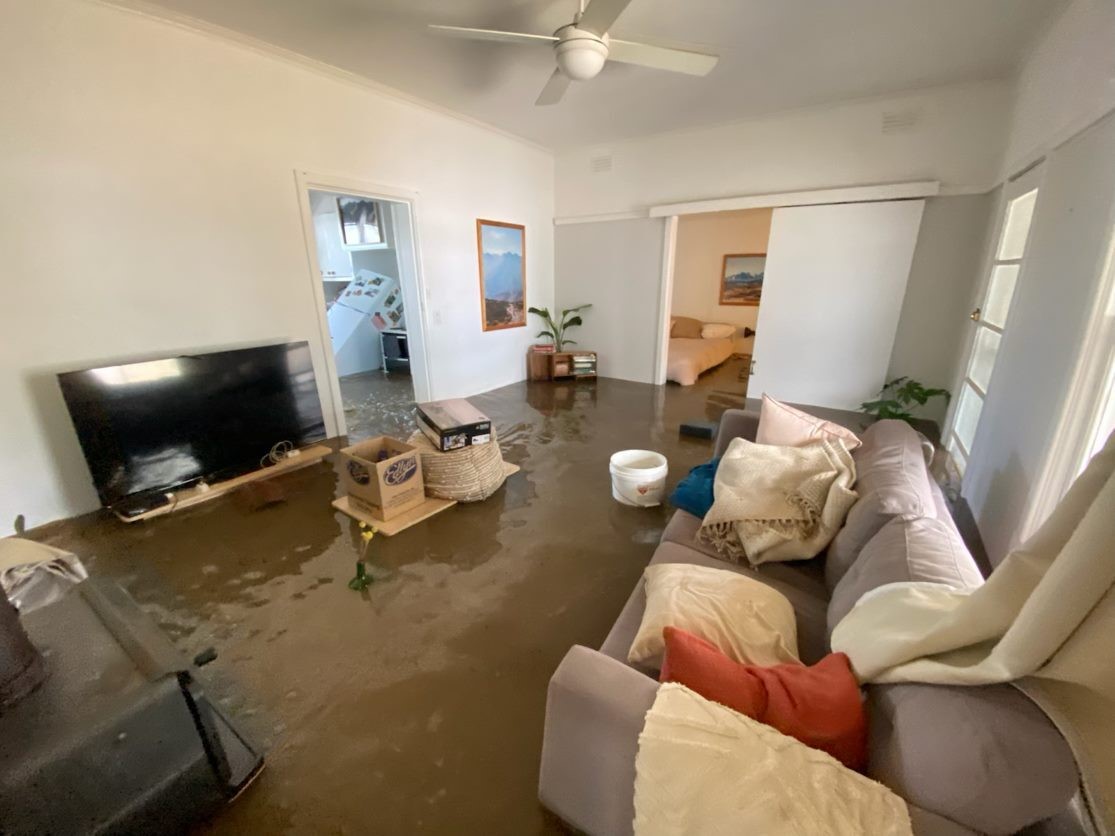 Picture shows a flooded living room.