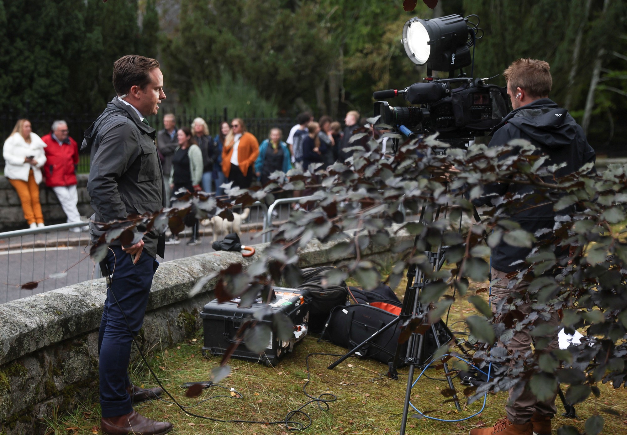 A person stands in front of a camera.