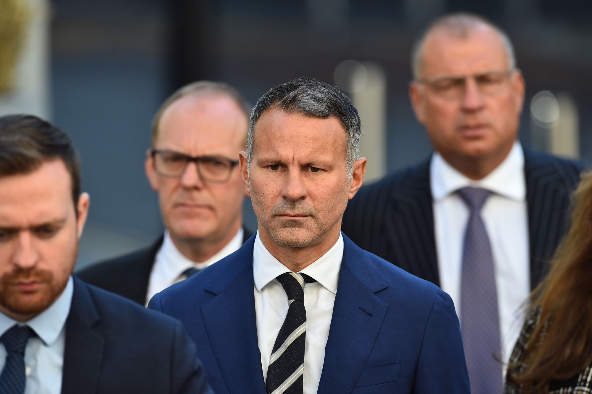 Former Manchester United footballer Ryan Giggs, centre, arrives at Manchester Crown Court