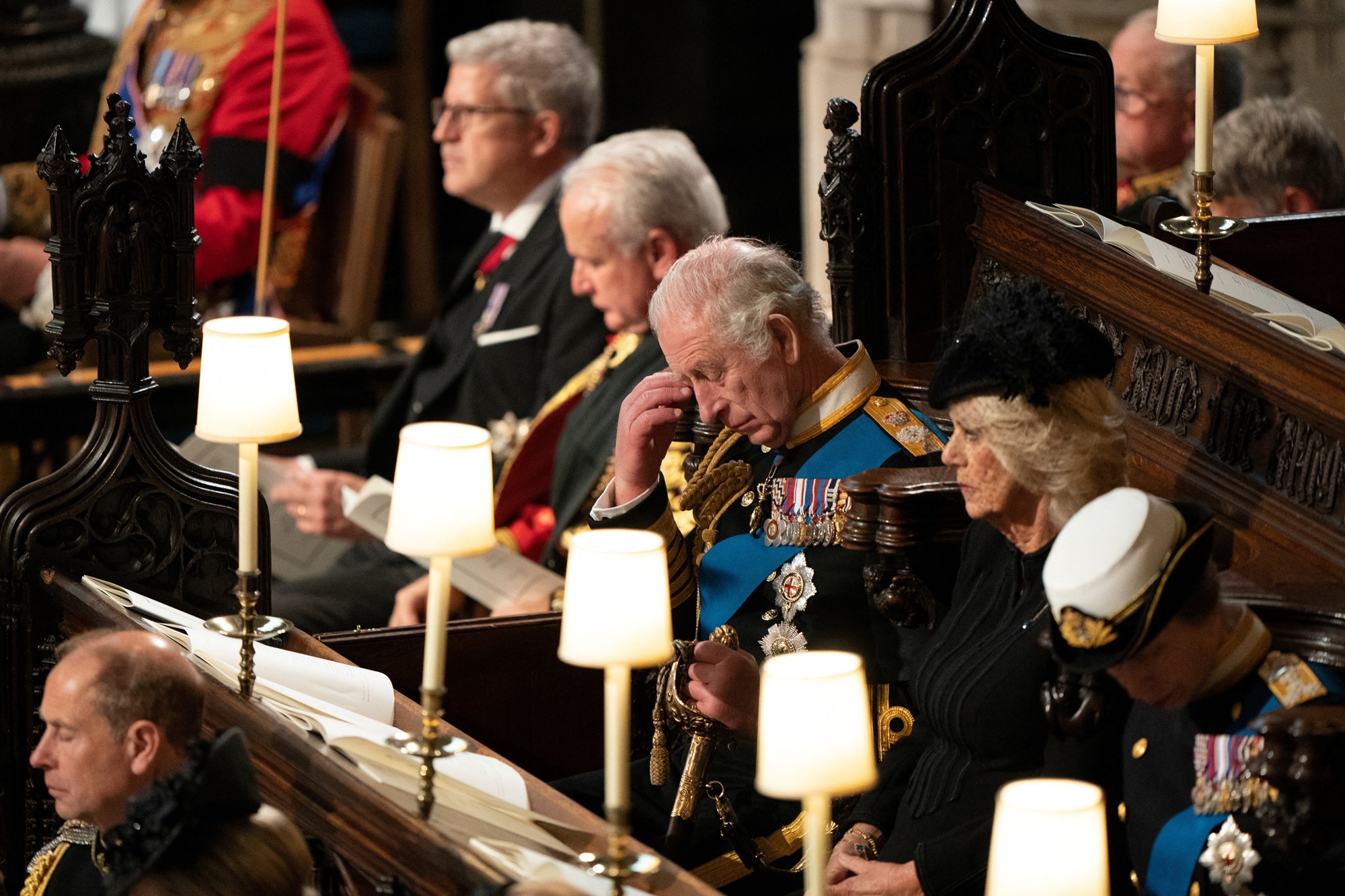 King Charles sits with Camilla during the Committal service