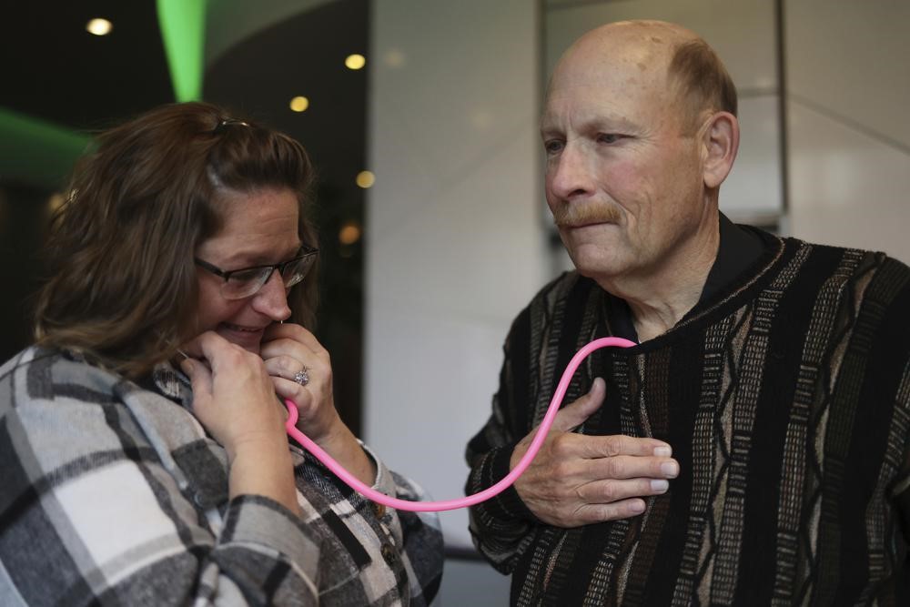 Amber Morgan, from South Bend, Ind., listens to the heartbeat of Tom Johnson, from Kankakee, at Travelodge by Wyndham Downtown Chicago, on Saturday, Nov. 19, 2022, in Chicago