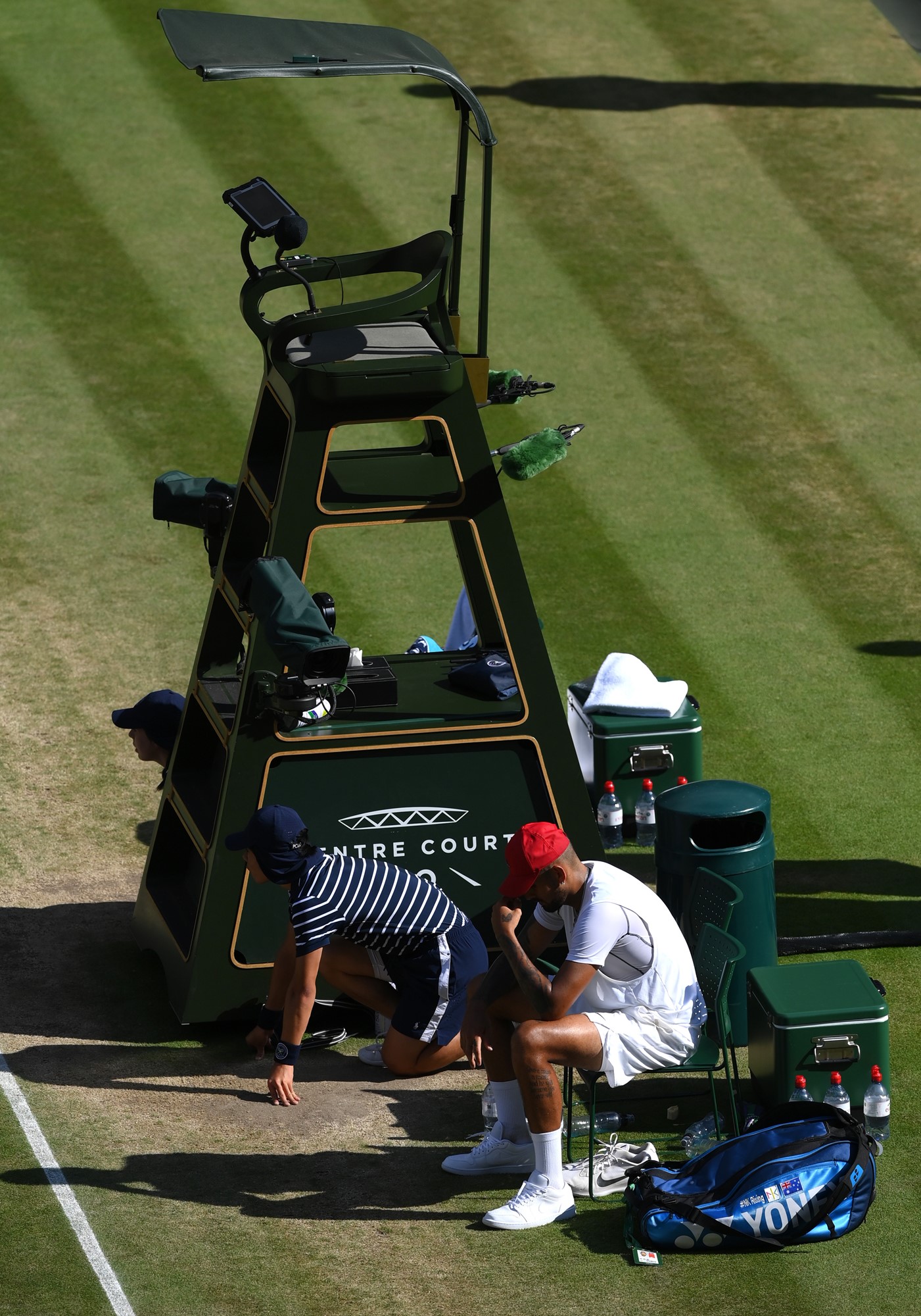 Nick Kyrgios slumps in his chair after losing the Wimbledon final.