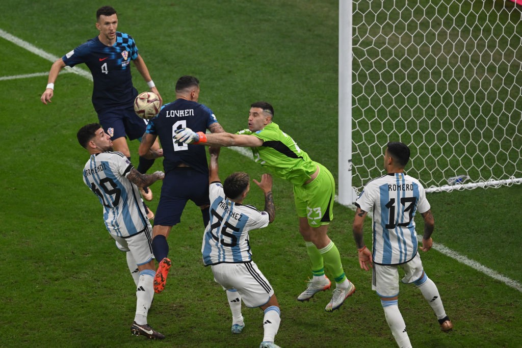 Argentina goalkeeper Emiliano Martinez punches the ball away from goal in the FIFA World Cup semifinal against Croatia.