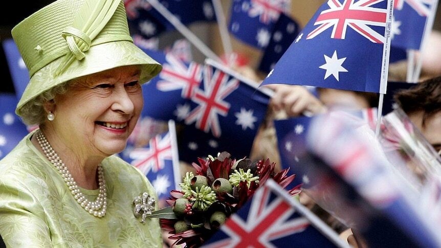 The Queen smiles as crowds wave Australian flags