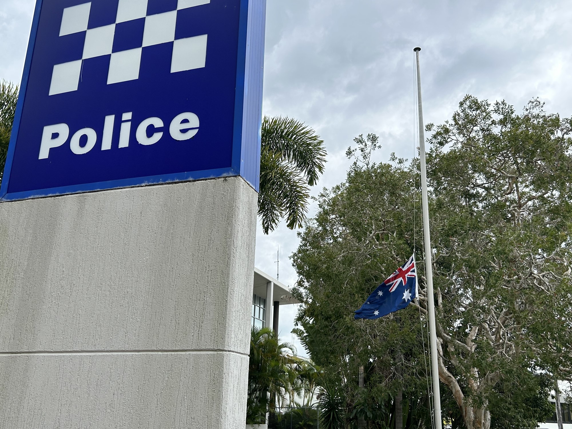 The flag outside a police station flies at half mast. 