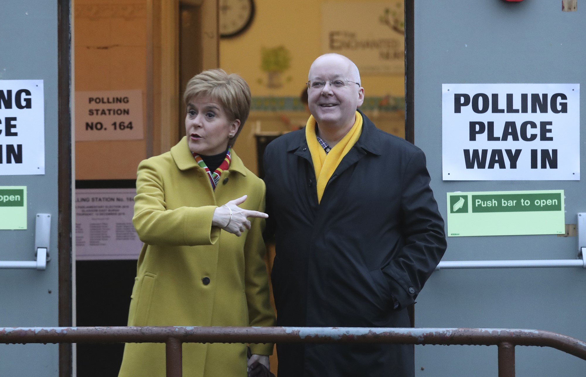 Nicola Sturgeon stands with her husband outside a Polling venue. 