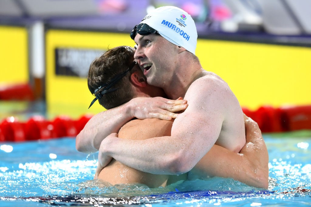 Two men hug in the pool