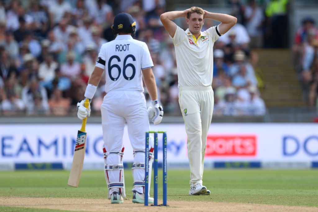 Cameron Green puts his hands on his head as Joe Root looks on.